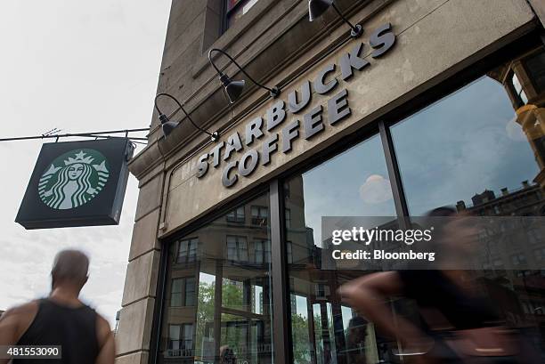 Pedestrians walk past a Starbucks Corp. Location at Union Square in New York, U.S., on Tuesday, July 21, 2015. Starbucks Corp. Is scheduled to...