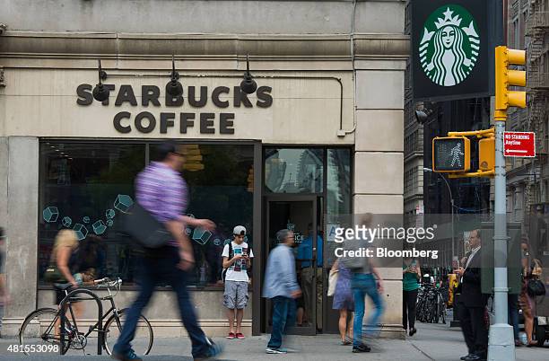 Pedestrians walk past a Starbucks Corp. Location at Union Square in New York, U.S., on Tuesday, July 21, 2015. Starbucks Corp. Is scheduled to...