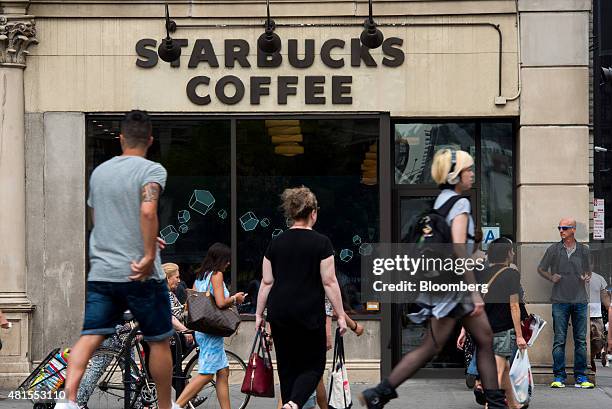 Pedestrians walk past a Starbucks Corp. Location at Union Square in New York, U.S., on Tuesday, July 21, 2015. Starbucks Corp. Is scheduled to...