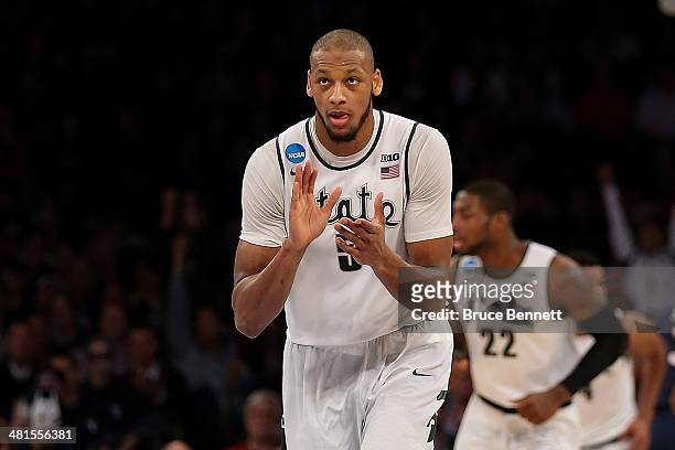 Adreian Payne of the Michigan State Spartans reacts after a basket against the Connecticut Huskies during the East Regional Final of the 2014 NCAA...
