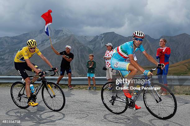 Vincenzo Nibali of Italy riding for Astana Pro Team attacks Chris Froome of Great Britain riding for Team Sky in the overall race leader yellow...