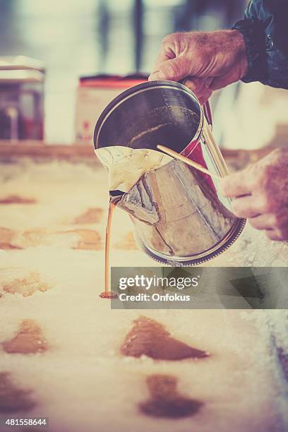 maple sugar taffy on snow at sugar shack - sugar shack stockfoto's en -beelden