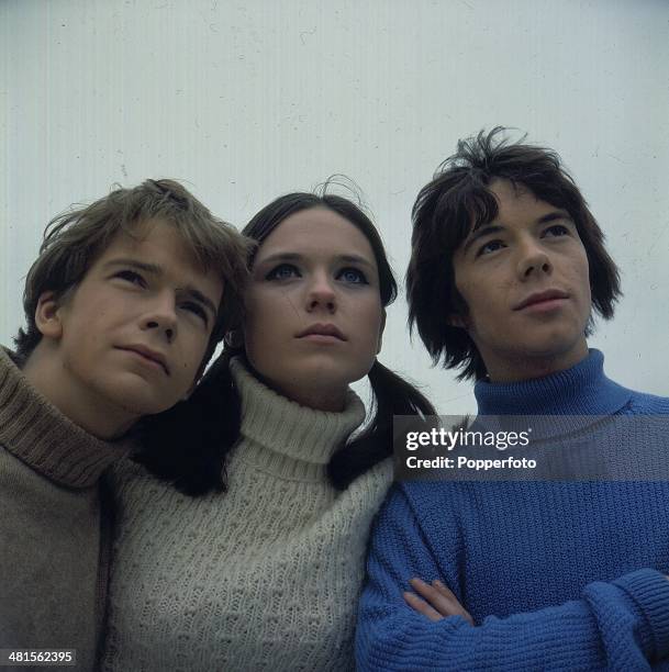 British actress Mary Maude posed with actors Tom Owen and Gregory Phillips on the set of the television series 'Freewheelers' in 1968.