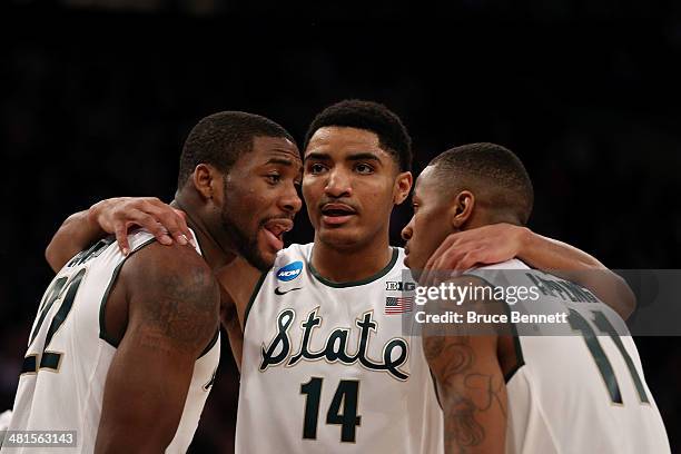 Branden Dawson, Gary Harris and Keith Appling of the Michigan State Spartans talk against the Connecticut Huskies during the East Regional Final of...