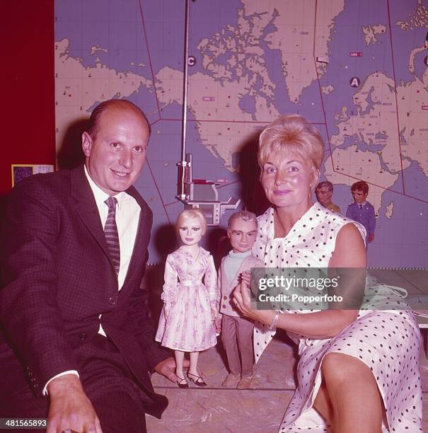 English film and television producer Gerry Anderson and his wife Sylvia Anderson posed holding the puppet characters 'Lady Penelope' and 'Jeff Tracy'...