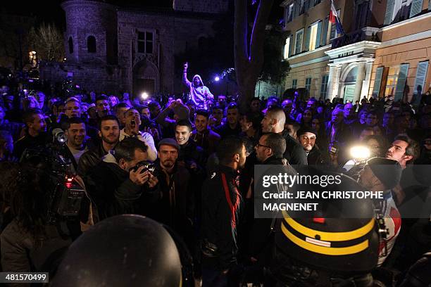 People demonstrate in front of the campaign headquarters of the French far-right National Front party, after the FN candidate David Rachline won the...