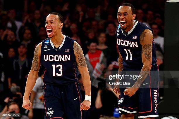 Shabazz Napier and Ryan Boatright of the Connecticut Huskies reacts after a play late in the game against the Michigan State Spartans during the East...