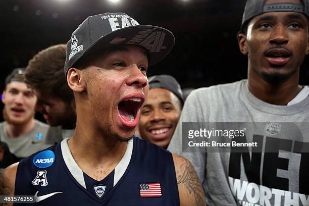 Shabazz Napier of the Connecticut Huskies celebrates after defeating the Michigan State Spartans to win the East Regional Final of the 2014 NCAA...