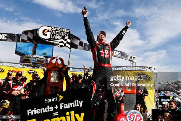 Kurt Busch, driver of the Haas Automation Chevrolet, celebrates in Victory Lane after winning the NASCAR Sprint Cup Series STP 500 at Martinsville...