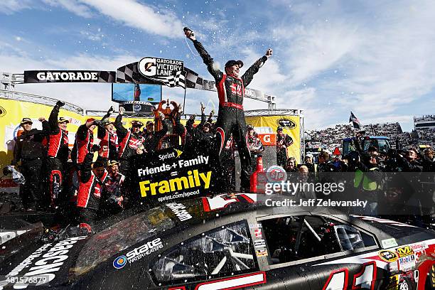 Kurt Busch, driver of the Haas Automation Chevrolet, celebrates in Victory Lane after winning the NASCAR Sprint Cup Series STP 500 at Martinsville...