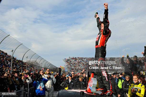 Kurt Busch, driver of the Haas Automation Chevrolet, celebrates in Victory Lane after winning the NASCAR Sprint Cup Series STP 500 at Martinsville...