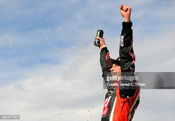 Kurt Busch, driver of the Haas Automation Chevrolet, celebrates in Victory Lane after winning the NASCAR Sprint Cup Series STP 500 at Martinsville...