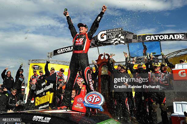 Kurt Busch, driver of the Haas Automation Chevrolet, celebrates in victory lane after winning the NASCAR Sprint Cup Series STP 500 at Martinsville...