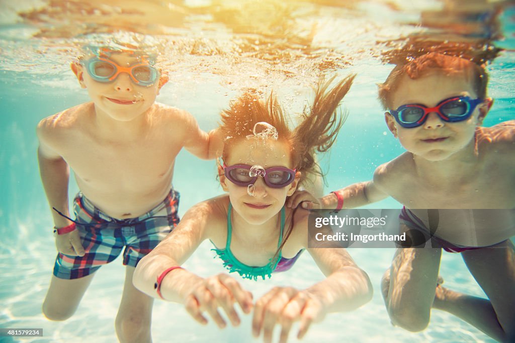 Kids swimming underwater