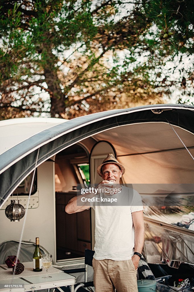 Man camping in his caravan at camping