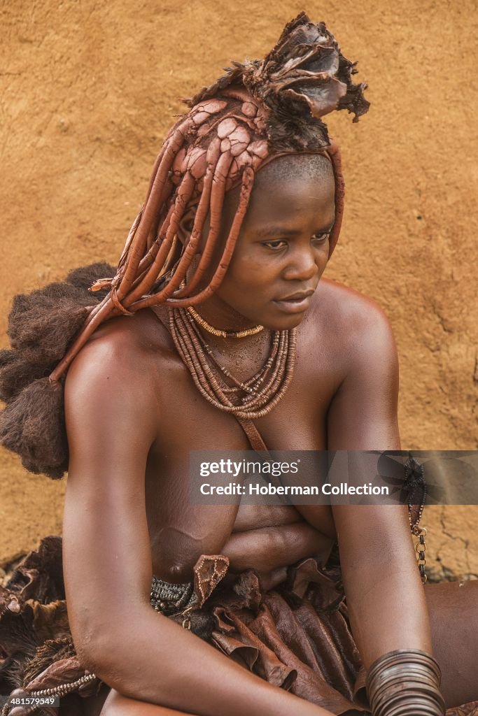 Himba Woman With Braided Hair And scented Red Body