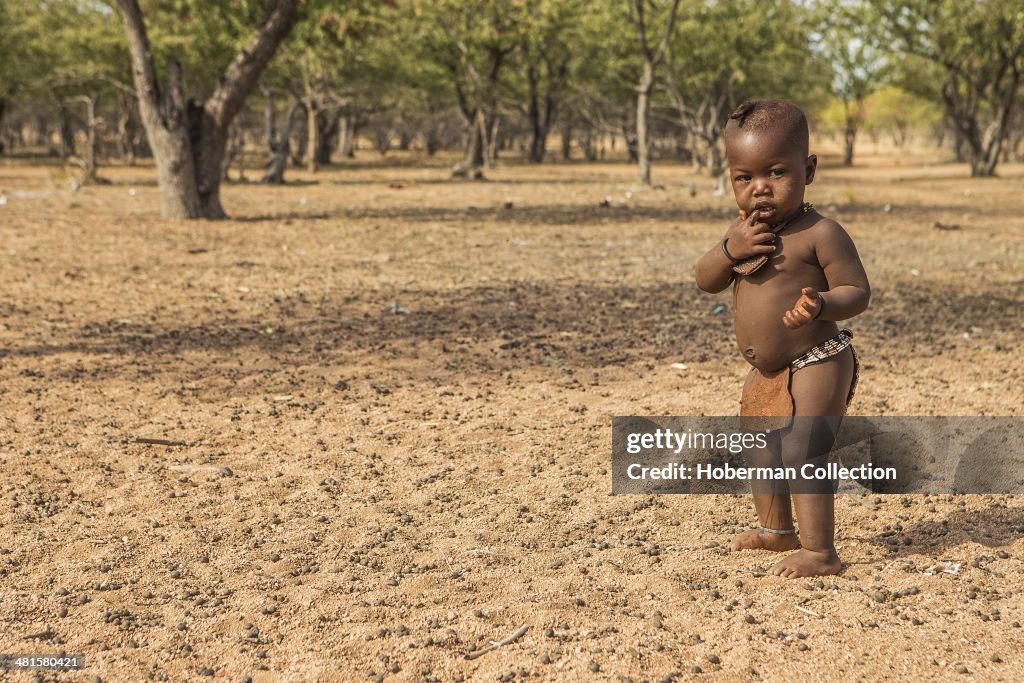 Young Himba Boy at his village near Opuwo. Namibia.