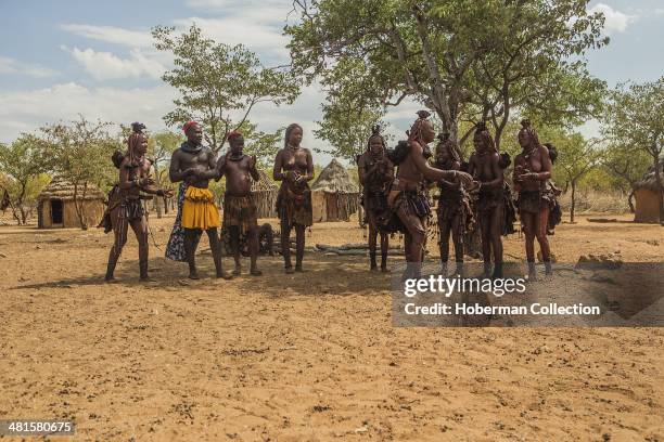 Himba Women Dancing And Clapping Hands At Their Village Near Opuwo. Namibia.