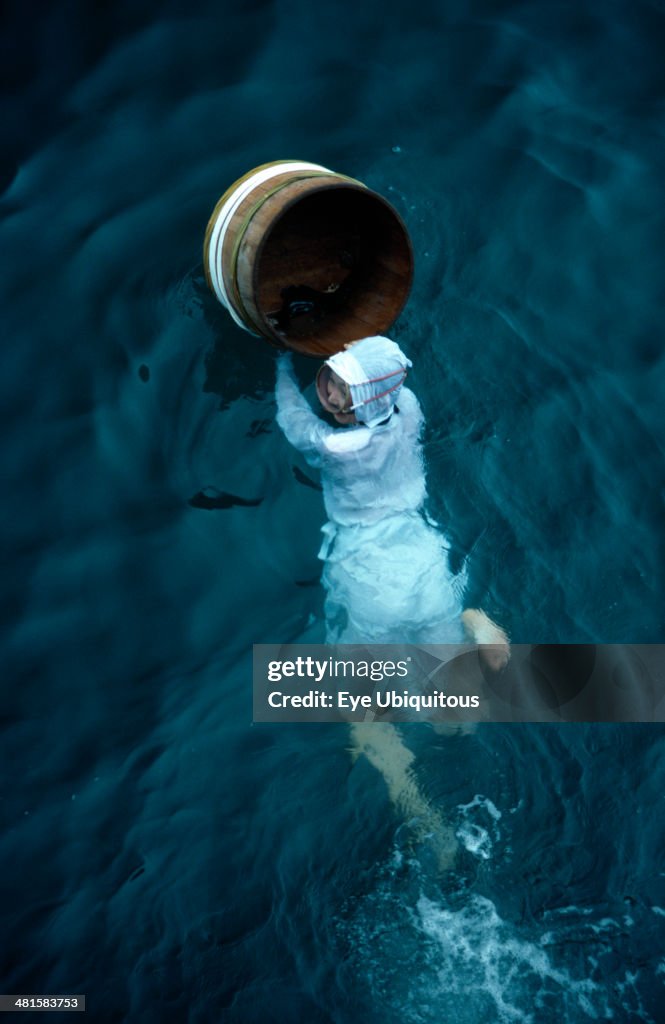 Traditional female pearl diver swimming in the water