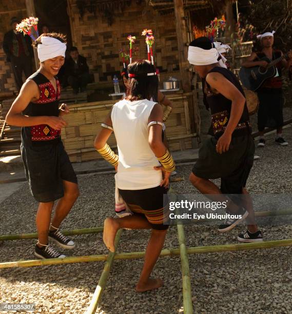 India Nagaland People Naga Warrior tribe performing bamboo dance.