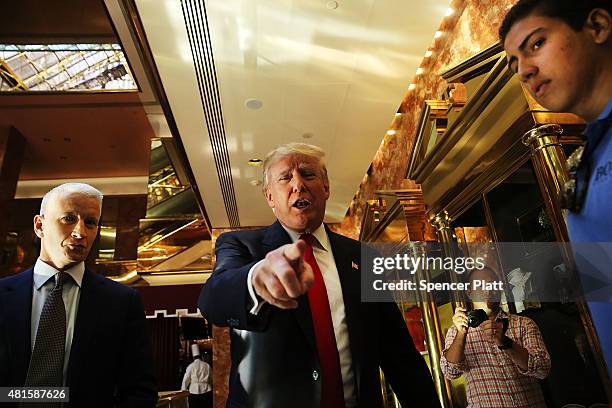 Donald Trump greets supporters, tourists and the curious after taping an interview with Anderson Cooper at a Trump owned building in mid-town...