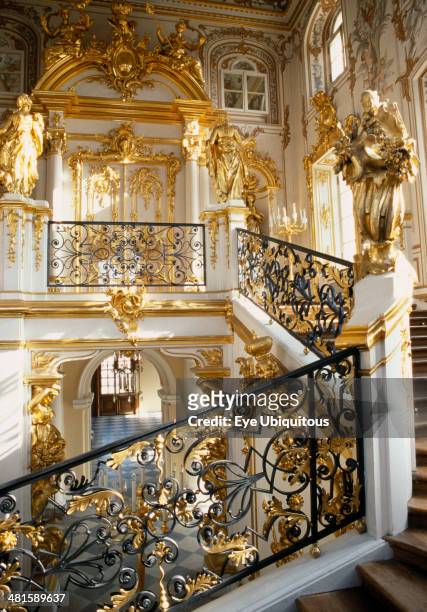 Russia, St Petersburg, Peterhof, Great Palace. Interior, detail of the main staircase and ornate gold and white baroque decorative style.