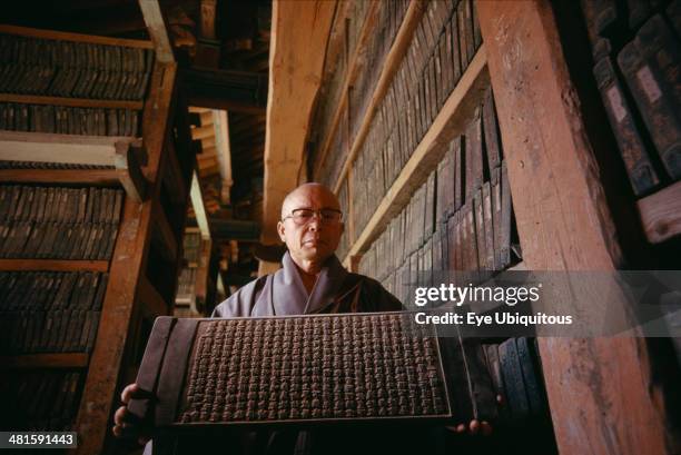 South Korea, South Kyongsan, Mount Kaya, Temple of Haeinsa. Monk with one of the Tripitaka Korean, most complete collection of Buddhist texts...