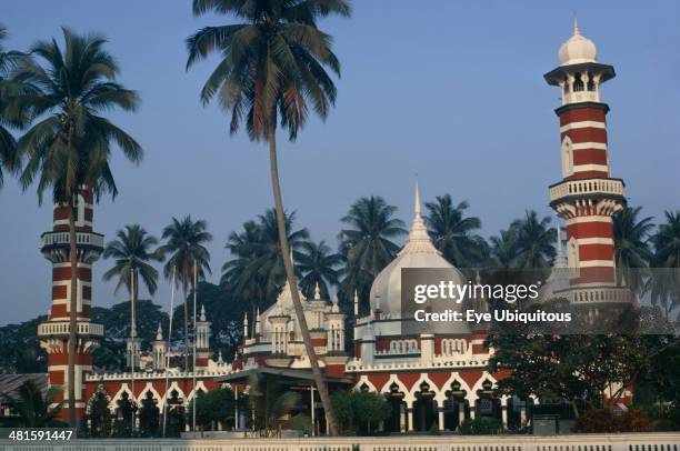 Malaysia, Kuala Lumpur, Masjid Jamek or Friday Mosque. Exterior with domed roof and red and white striped minarets.