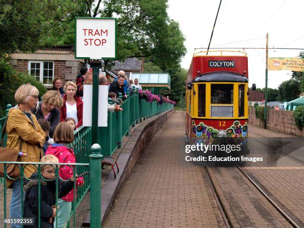 Queue of people at the Tram Stop, Colyton waiting for the tram to arrive from Seaton, Devon, UK.