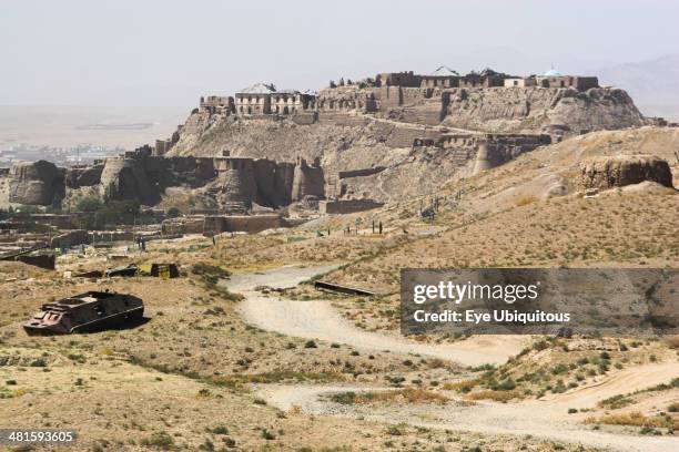 Afghanistan, Ghazni, Military graveyard with ancient city walls and Citadel in background, the Citadel was destroyed during First Anglo Afghan war...