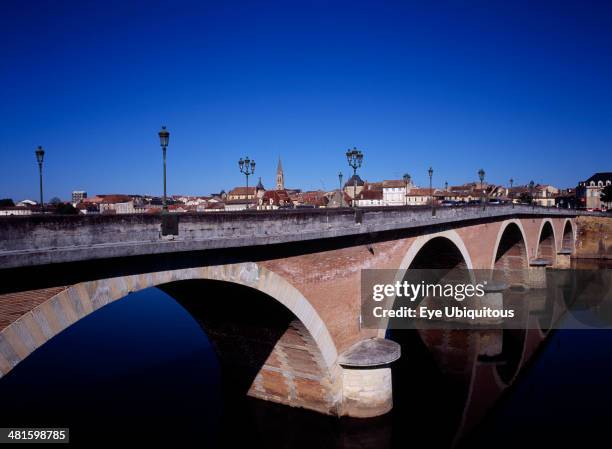 France, Dordogne, Perigeux, Bergerac. View along old bridge crossing River Dorgogne from south with town beyond.