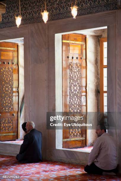 Turkey Istanbul, Sultanahmet Camii Blue Mosque interior with men at worship