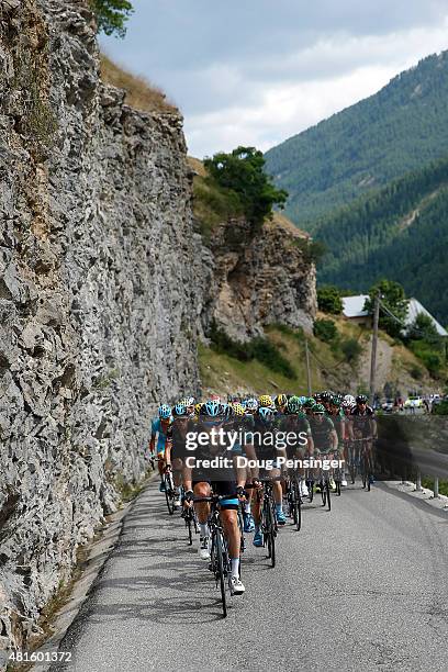 Team Sky controls the peloton in defense of the overall race leader yellow jersey of Chris Froome of Great Britain riding for Team Sky in the Col...