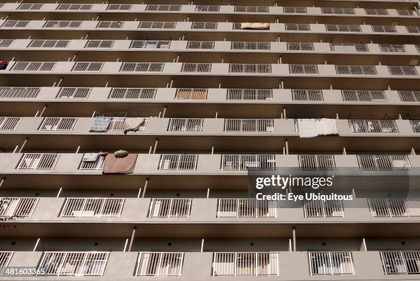 Japan Honshu Tokyo Exterior or an apartment block with futon mattresses hung over balcony rails to dry.