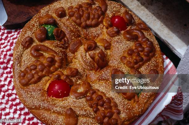 Greece, Saronic Islands, Spetses, Easter bread decorated with painted hard boiled eggs and sesame seeds