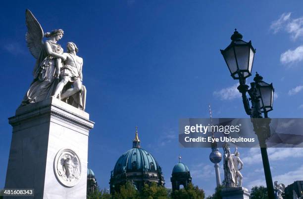 Germany, Berlin, Statues and street lamps on Schlossbrucke or Castle Bridge with Cathedral and Alexanderplatz Television Tower