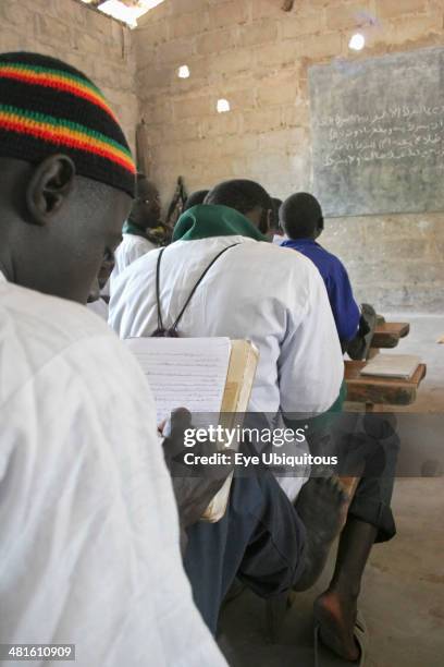 Gambia, Western Gambia, Tanji, Tanji Village. Muslim boys writing in Arabic at their desks while attending an Islamic religious class at the Ousman...