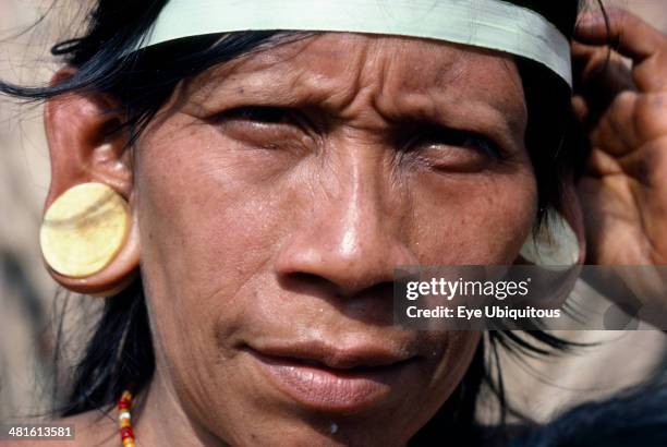 Ecuador, Amazon, People, Portrait of a Waorani Indian woman wearing balsa ear plugs.