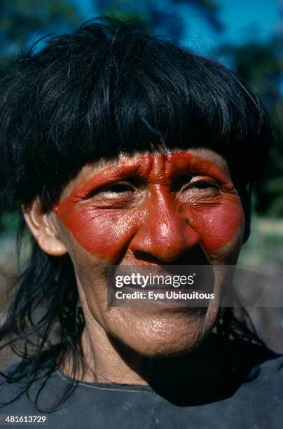 Ecuador, Amazon, People, Portrait of Auca Indian with red face paint from achole plant.