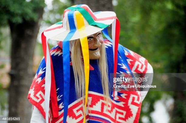 Mexico, Michoacan, Patzcuaro, Dancer in mask and costume performing Danza de los Viejitos or Dance of the Little Old Men in Plaza Vasco de Quiroga.