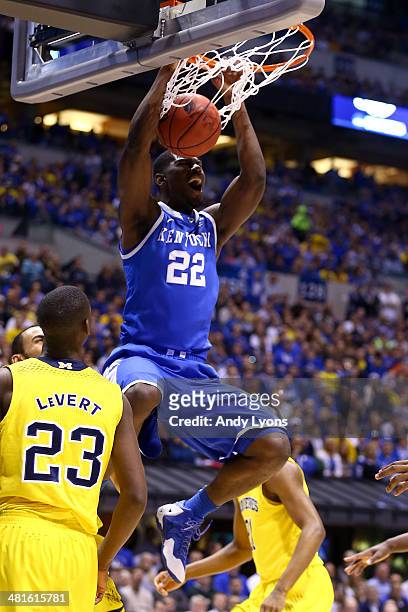 Alex Poythress of the Kentucky Wildcats dunks the ball over Caris LeVert of the Michigan Wolverines in the first half during the midwest regional...