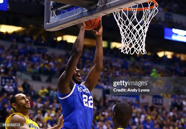 Alex Poythress of the Kentucky Wildcats dunks the ball over Caris LeVert of the Michigan Wolverines in the first half during the midwest regional...