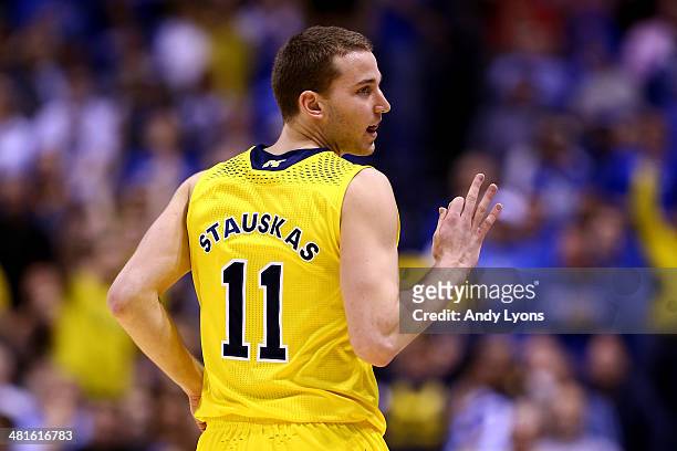 Nik Stauskas of the Michigan Wolverines celebrates a three pointer in the first half against the Kentucky Wildcats during the midwest regional final...