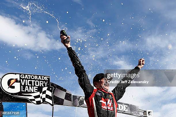 Kurt Busch, driver of the Haas Automation Chevrolet, celebrates in Victory Lane after winning the NASCAR Sprint Cup Series STP 500 at Martinsville...