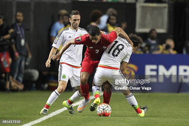 Valentin Pimentel of Panama tries to evade the mark of Andres Guardado of Mexico during a semi final match between Mexico and Panama as part of Gold...