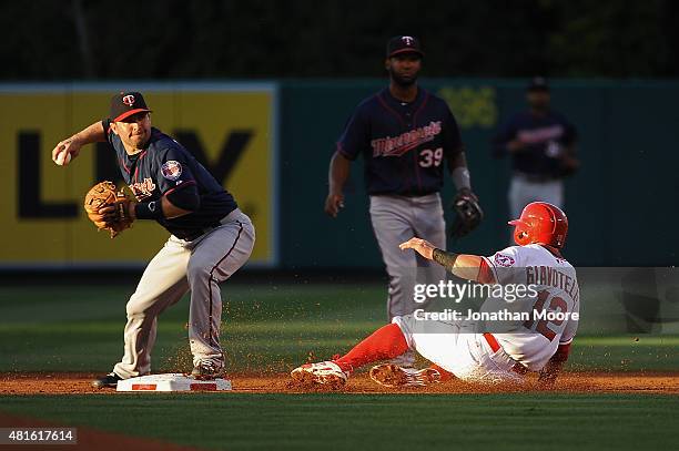 Johnny Giavotella of the Los Angeles Angels of Anaheim is tagged out at second base by Brian Dozier of the Minnesota Twins during the first inning at...