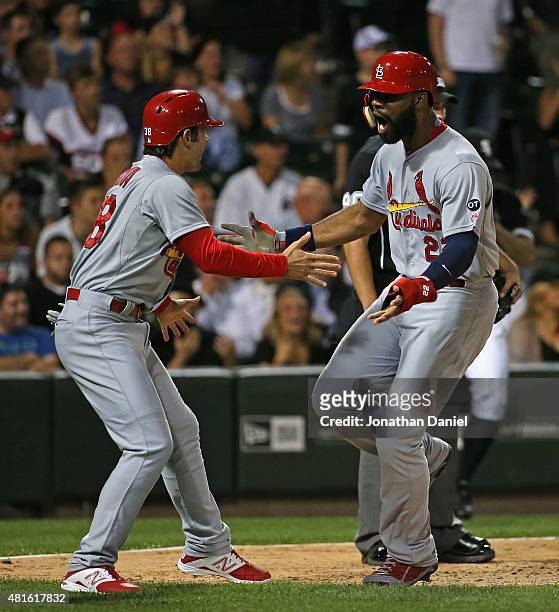 Pete Kozma and Jason Heyward of the St. Louis Cardinals celebrate scoring runs in the 8th inning against the Chicago White Sox at U.S. Cellular Field...