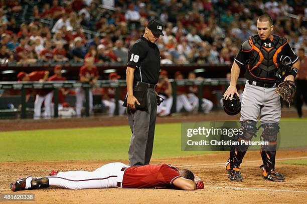 David Peralta of the Arizona Diamondbacks lays motionless on the ground after being hit in the head by a pitch from starting pitcher Jose Fernandez...