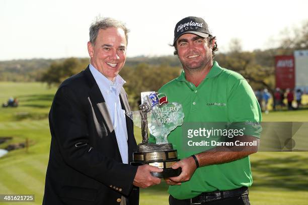 Champion Steven Bowditch poses with President of Valero Energy Company Joe Gorder and the trophy during the Final Round of the Valero Texas Open at...