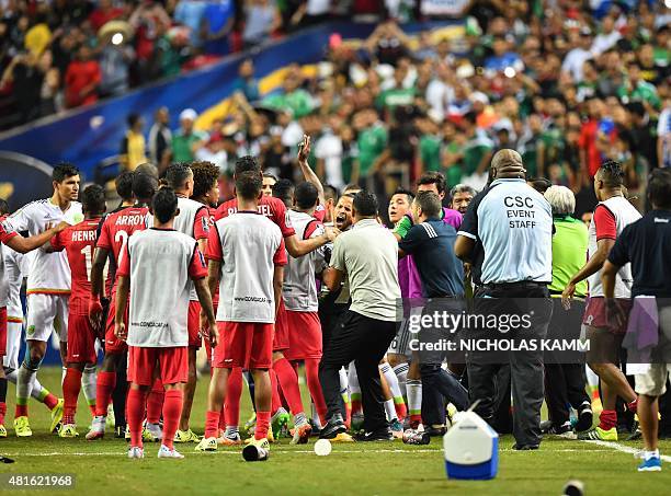 Scuffles break between members of Panama's and Mexico's national teams after the referee awarded Mexico a controversial penalty during g a CONCACAF...